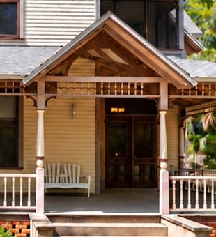 The gabled porch entry and front doors.